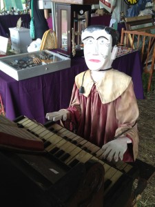 a wooden puppet playing an organ- i said everything!
