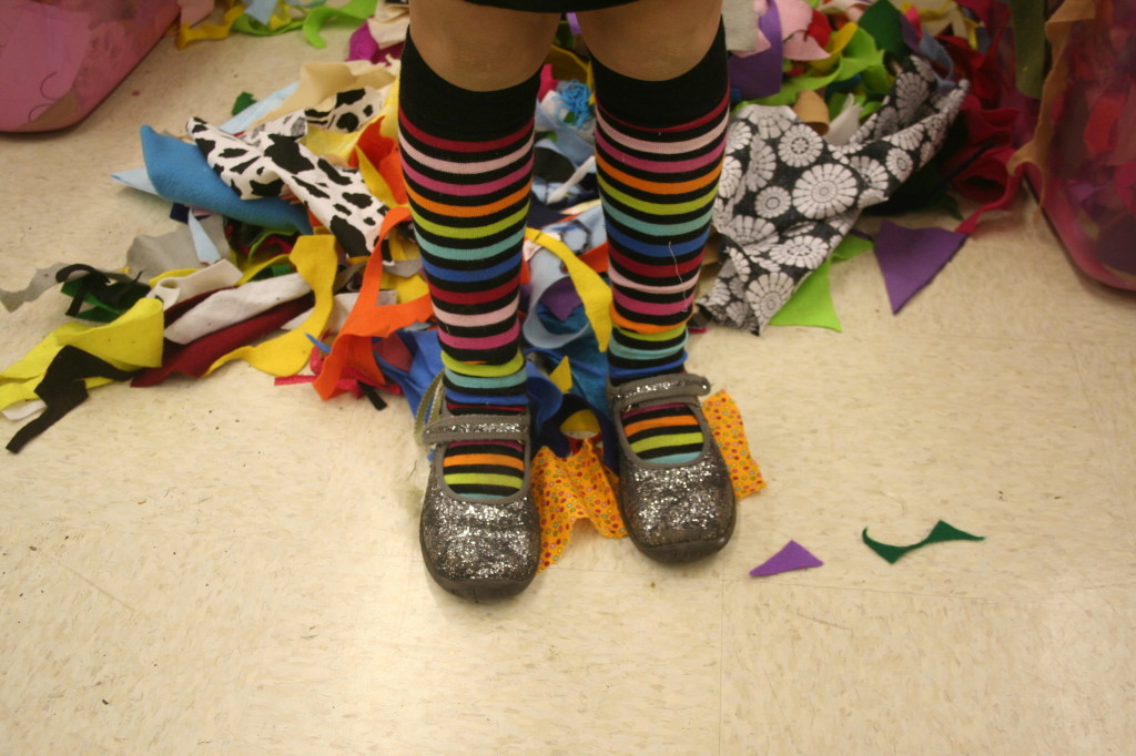one of the kids at the community center. those kids have the best sense of style! hello... rainbow striped socks and silver glitter shoes!